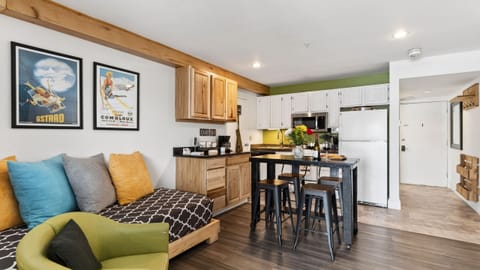 Studio space featuring a daybed and a modern kitchen island.