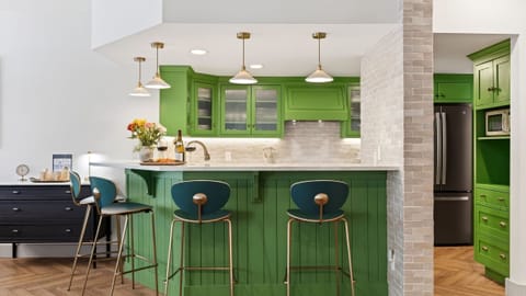 Sunlit dining nook with a cozy banquette and round table—perfect for shared meals, games, and slow mornings.
