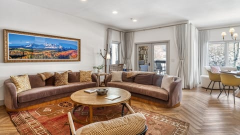 Spacious living area with plush seating, mountain-inspired décor, a fireplace, and a smart TV—perfect for relaxing after a day in Telluride.