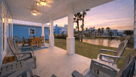 Savor outdoor dining on the covered patio overlooking a community pond and palm trees.