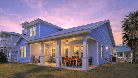 Rear view of the house and spacious backyard & patio.