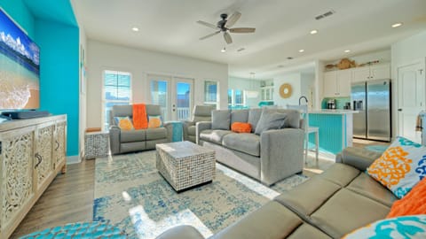 Bright, open-concept living space with coastal décor, plush seating, and easy flow into the kitchen—perfect for relaxing after a day in Port A.