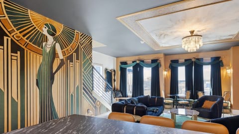 Stylish living room with plush seating, statement chandelier, and open-concept layout.