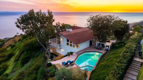 Sunset views over the Pacific with a private pool and hillside setting.