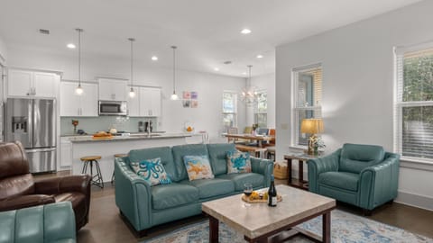 Bright living room with ample seating and a large TV—perfect for movie nights.