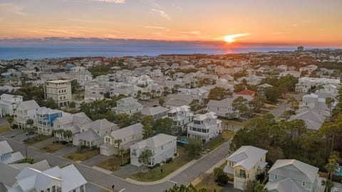 Golden-hour views over the neighborhood with the Gulf shimmering in the distance.