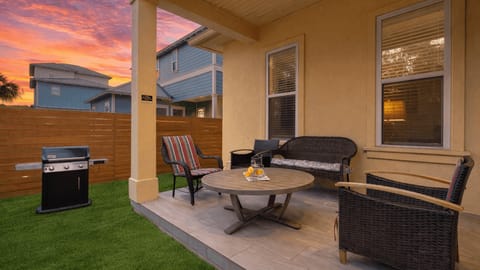 Covered patio with comfortable seating and a grill for easy outdoor meals.