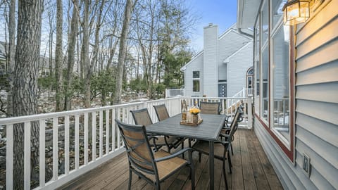 A private deck set among the trees, offering peaceful outdoor dining and fresh mountain air year-round.