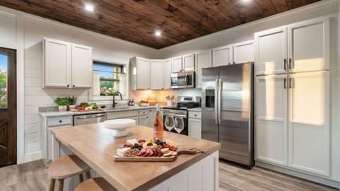 Bright, fully equipped kitchen with a large island, modern appliances, and plenty of space for gathering and meal prep.
