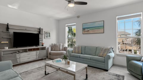 Bright, coastal-inspired living room with comfortable seating and natural light.