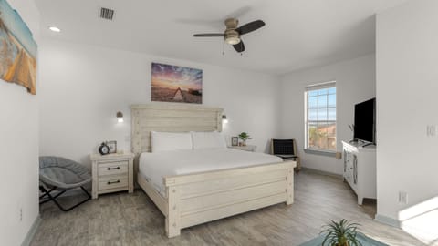 The primary bedroom features a king bed, TV, and an ensuite bathroom.