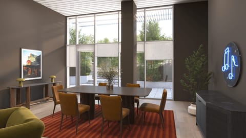 Spacious dining area featuring a large table, warm wood accents, and floor-to-ceiling windows.