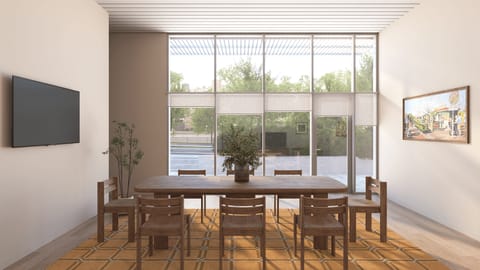 A formal dining space with a large wooden table set against floor-to-ceiling windows.
