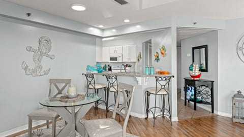 Serene bedroom with a queen-sized bed, navy accents, and large windows for natural light.