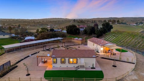 Sweeping vineyard views surround this private two-home Paso Robles retreat.