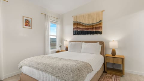 Shimla Syrah's primary bedroom features a queen bed, TV, and an ensuite bathroom.