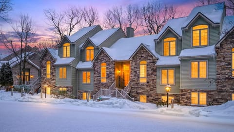Stunning exterior view of the mountain home illuminated against a winter sunset.