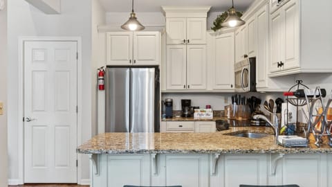 Fully equipped kitchen featuring spacious countertops and stainless steel appliances.