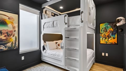 Bedroom 2 features a queen-over-queen bunk bed and a TV.