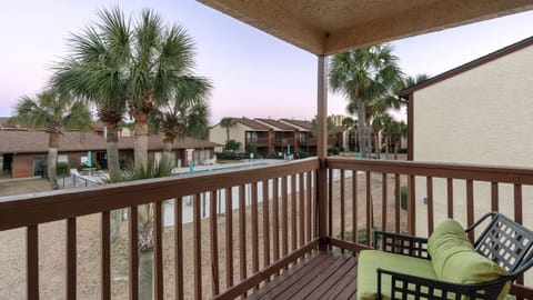 Primary bedroom's balcony with seating.
