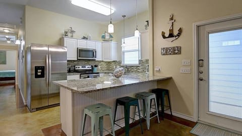 Gourmet kitchen with a large breakfast bar with seating.