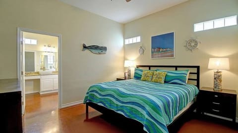 Primary bedroom with coastal decor and a ceiling fan.