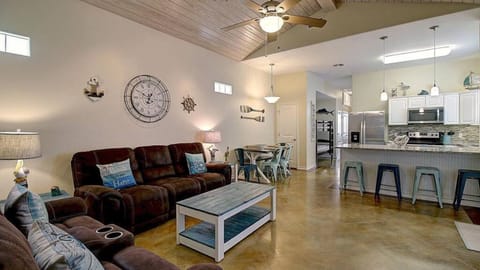 Alternate view of the living area showing the transition to the dining and kitchen space.