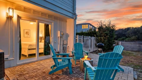 Sunset patio hangs—Adirondack chairs around the fire pit, grill ready, and cozy indoor comfort just steps away.