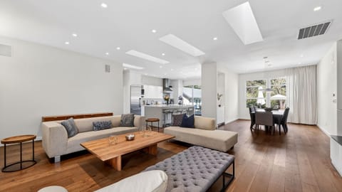 Sophisticated living space with vaulted ceilings, sleek fireplace, and curated modern furnishings designed for effortless relaxation.