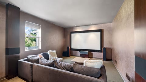 Private home theater with oversized projection screen and surround sound—perfect for movie nights, game days, and immersive entertainment.