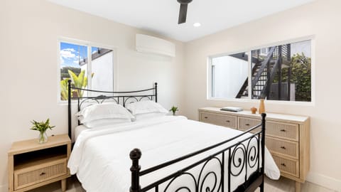 Bedroom 2 features a queen bed and a TV.