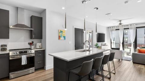 Open-concept kitchen + lounge with a spacious island for meals and mingling.