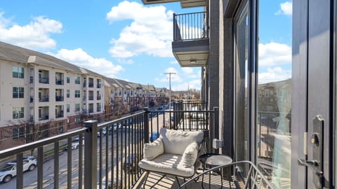 Sunny private balcony with comfy seating—perfect for coffee, fresh air, and city views.