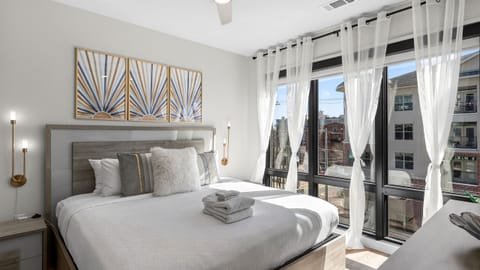 The primary bedroom features a king bed, TV and an ensuite bathroom.