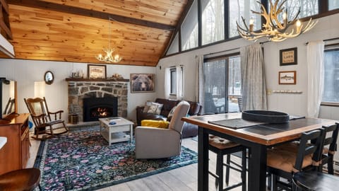 Warm and inviting open-concept living area with a stone fireplace.