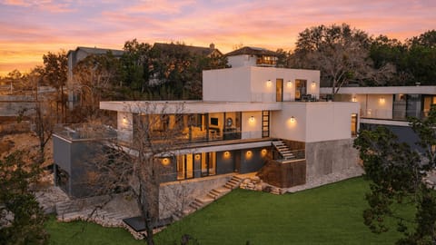 Striking modern Austin retreat with floor-to-ceiling glass and hillside views.