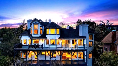 Dusk view of the multi-level mountain estate nestled in the trees.