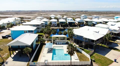 Community pool just steps away, surrounded by coastal cottages and wide-open bay views.