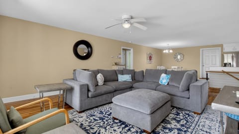 Spacious living room with a cozy sectional—perfect for movie nights and relaxing after a day in Charleston.