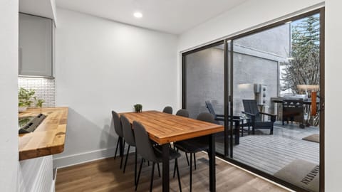 Bright dining nook with a seamless indoor-outdoor flow—steps to the deck for fresh air, grilling, and easy apres vibes.