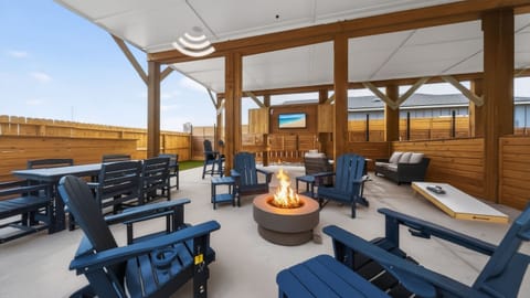 Covered patio lounge with a fire pit, outdoor dining, and plenty of seating for the whole crew.