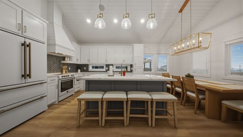 A chef-worthy coastal kitchen—spacious island seating, modern appliances, and a bright dining nook for easy family meals.