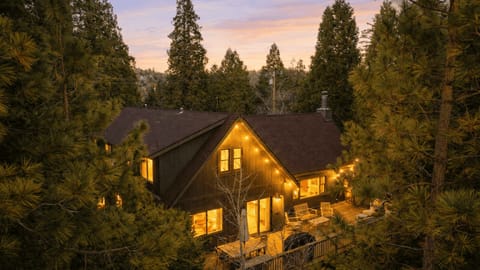 Golden hour magic in the pines—your Lake Arrowhead cabin glowing under a sunset sky.