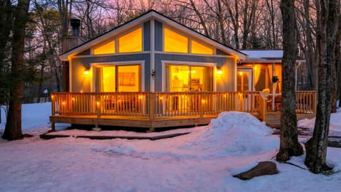The glowing Chalet-style facade at dusk.