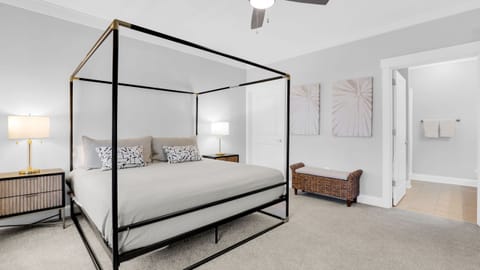 The primary bedroom features a king bed, TV, desk and an ensuite bathroom. (Deluxe 2-Bedroom Unit)