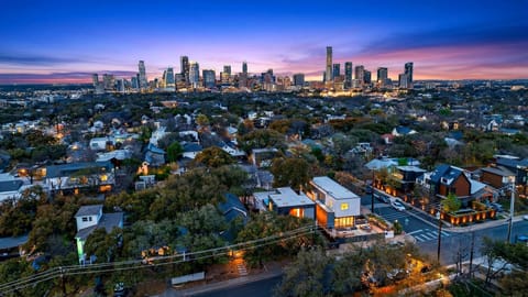 Sleek modern kitchen with statement tile, oversized island, and a dining setup made for gathering.