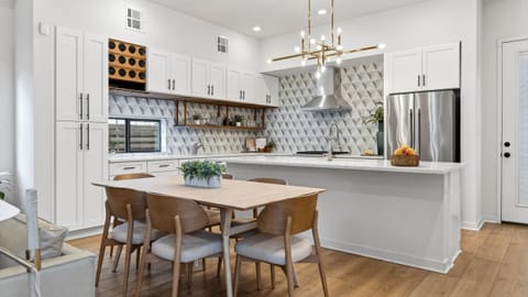 Airy, modern living room with a huge TV, cozy seating, and sliding doors to your private outdoor space.