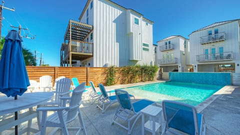 Shared community pool with lounge seating, steps from the Dune & Done.