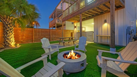 Gather around the firepit in the private backyard. (Dune & Done)