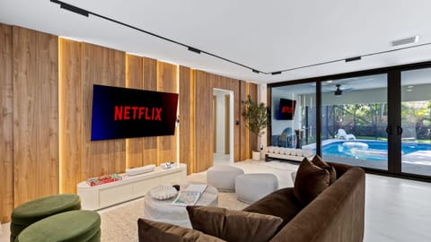 Stylish living room with direct access to the screened pool patio.